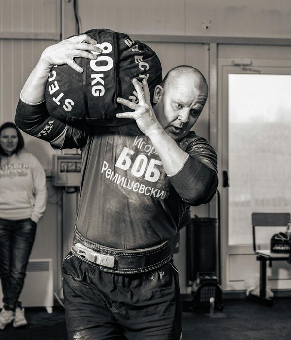 Man performing a strength exercise with focused expression.